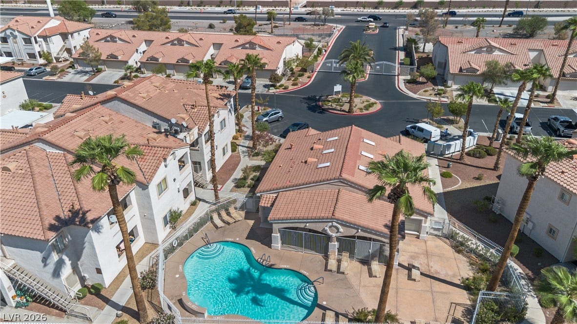 855 N Stephanie Street, #2615, Henderson, NV 89014 Tiled roofs and palm trees surround a sparkling community pool in this gated development.