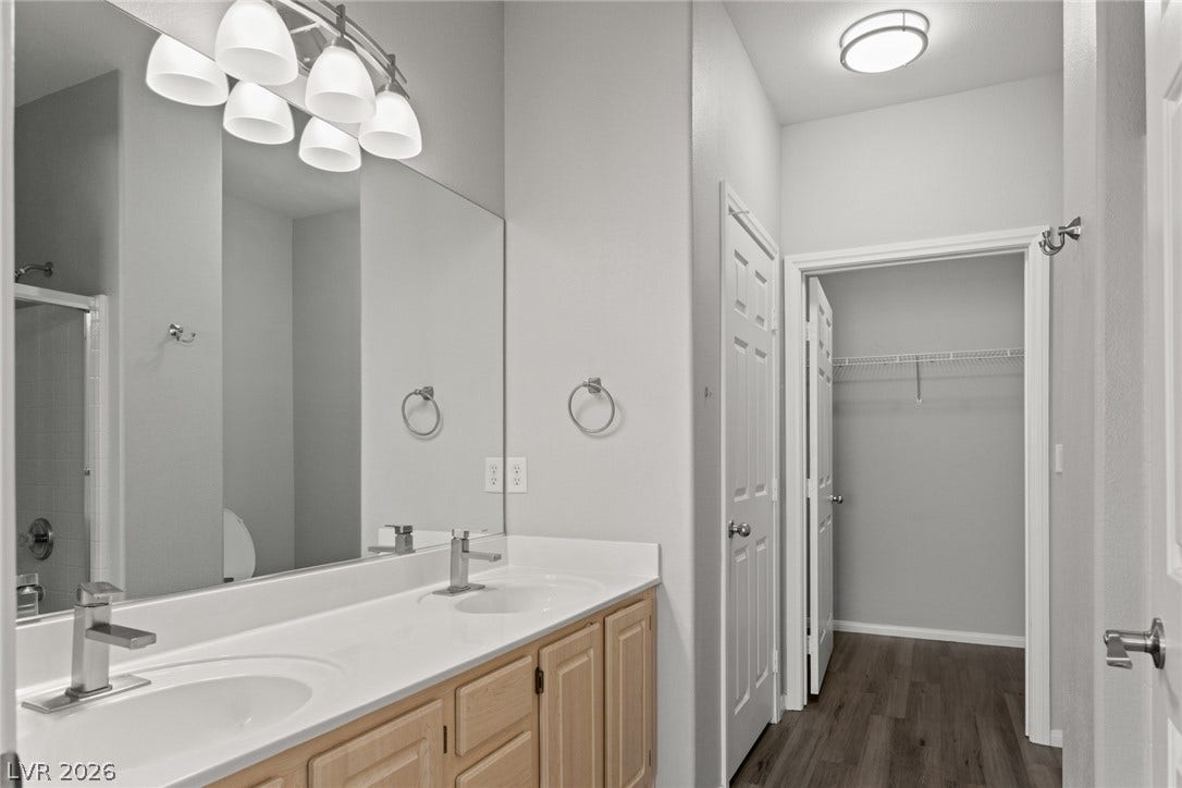 855 N Stephanie Street, #2615, Henderson, NV 89014 A spacious double vanity and hard surface flooring guide the way to a walk-in closet.