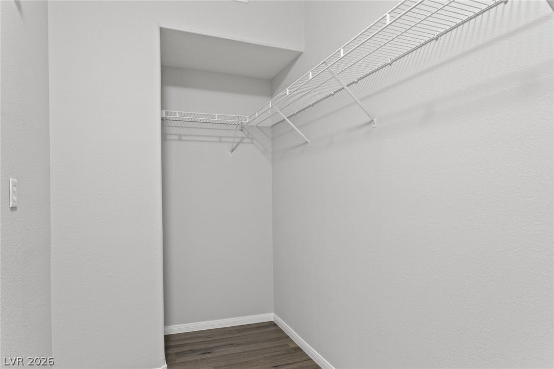 855 N Stephanie Street, #2615, Henderson, NV 89014 A spacious walk-in closet features built-in wire shelving and durable wood-look flooring.