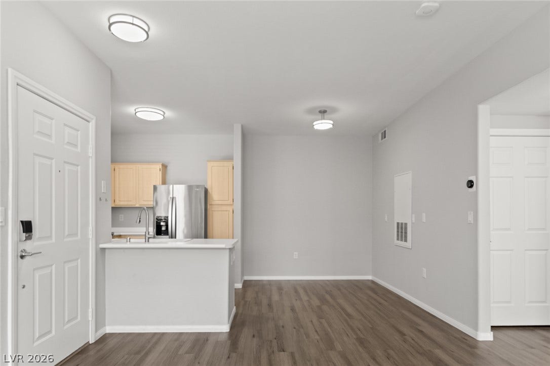 855 N Stephanie Street, #2615, Henderson, NV 89014 Smooth wood flooring flows throughout this open layout leading toward the kitchen area.