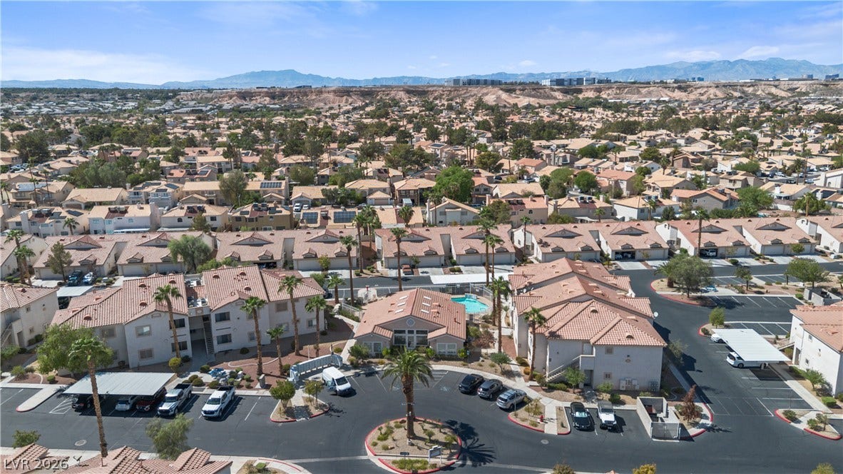 855 N Stephanie Street, #2615, Henderson, NV 89014 Distant mountains frame a sprawling community of tile-roofed residences.