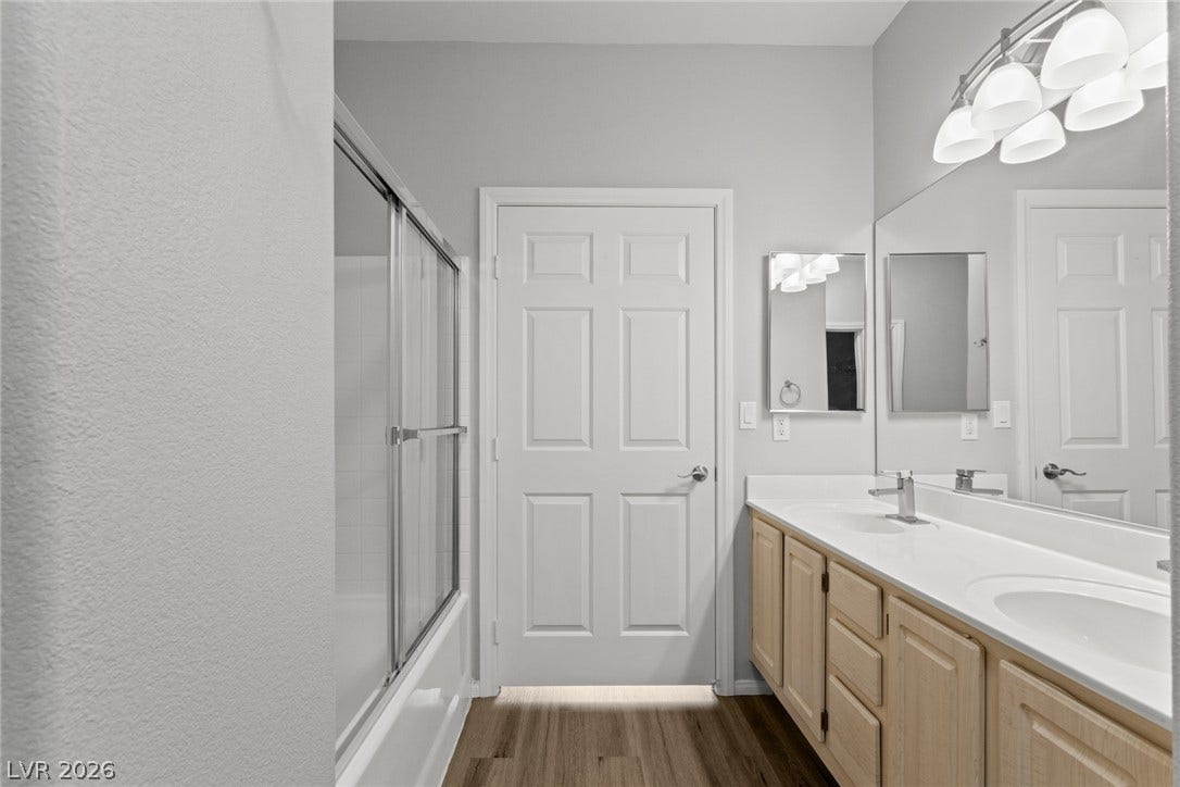 855 N Stephanie Street, #2615, Henderson, NV 89014 A spacious double vanity and a glass-enclosed tub complete this functional bathroom.