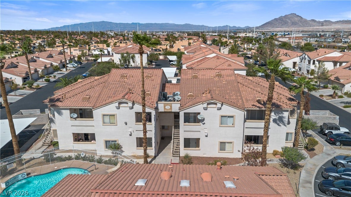 855 N Stephanie Street, #2615, Henderson, NV 89014 Spanish tile roofs and stucco exteriors blend beautifully against a scenic desert mountain backdrop.