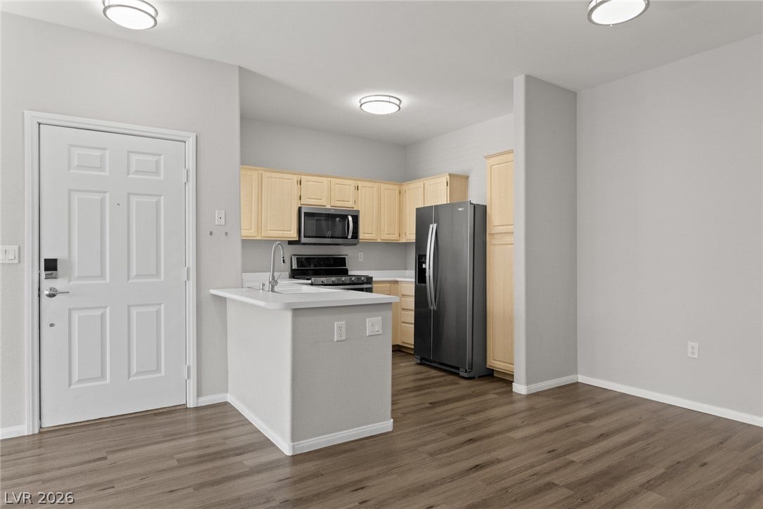 855 N Stephanie Street, #2615, Henderson, NV 89014 An open layout flows effortlessly from the entrance into a kitchen with wood-look flooring.