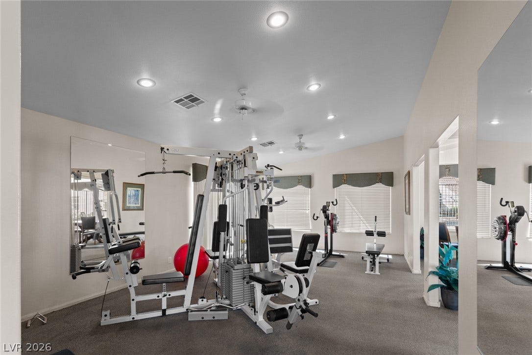 855 N Stephanie Street, #2615, Henderson, NV 89014 Recessed lighting illuminates this dedicated home fitness space complete with wall-to-wall carpeting and large windows.