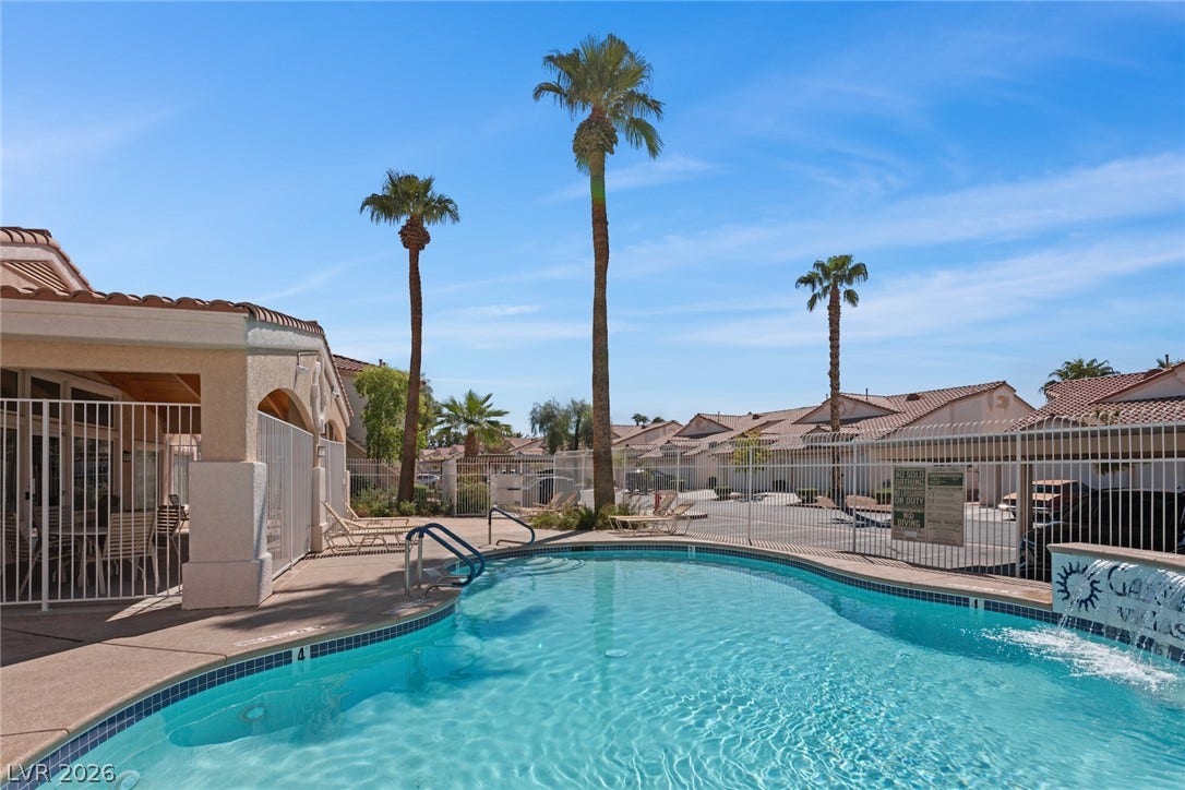 855 N Stephanie Street, #2615, Henderson, NV 89014 Palm trees frame a sparkling community pool set against clear desert skies.