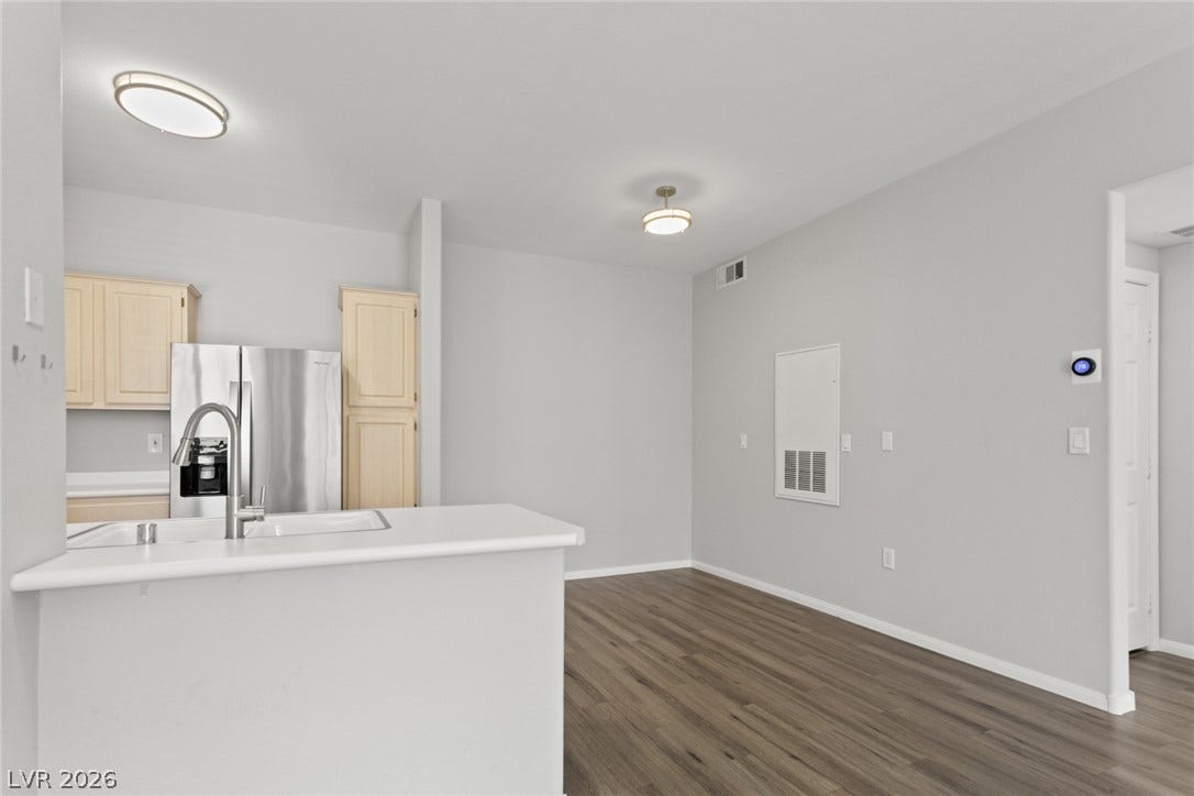 855 N Stephanie Street, #2615, Henderson, NV 89014 Gleaming wood-look floors anchor this open-concept space seamlessly connecting the kitchen and dining areas.