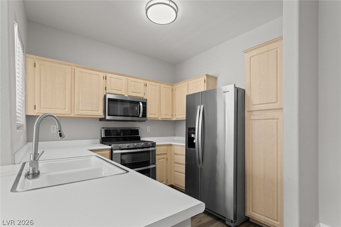 855 N Stephanie Street, #2615, Henderson, NV 89014 Ample wooden cabinetry and solid countertops define this highly functional culinary space.
