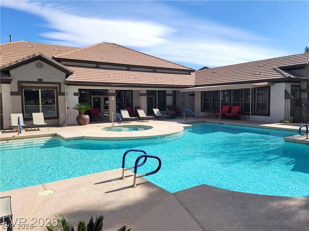 45 Maleena Mesa Street, #1912, Henderson, NV 89074 An inviting swimming pool and integrated spa sit adjacent to the tiled roof residence.