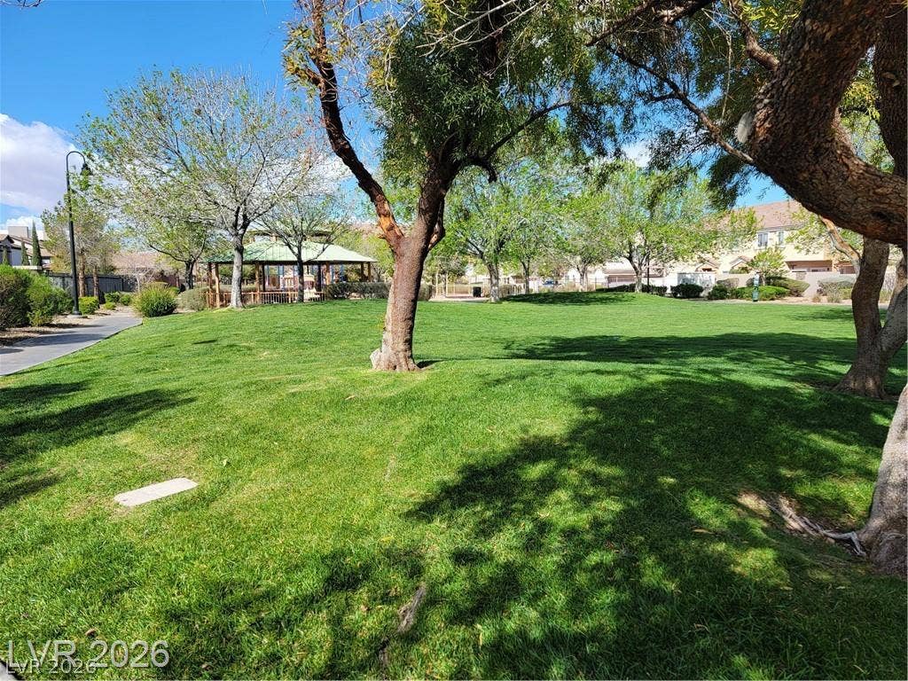 45 Maleena Mesa Street, #1912, Henderson, NV 89074 Mature trees shade a rolling green lawn near a community park and gazebo.