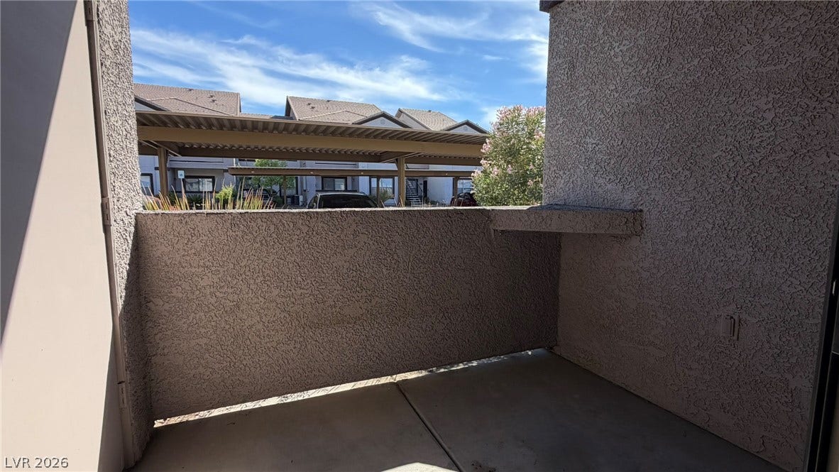 45 Maleena Mesa Street, #1912, Henderson, NV 89074 Concrete flooring and stucco walls define this private outdoor balcony.