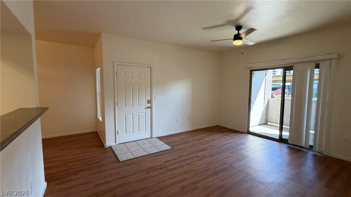 45 Maleena Mesa Street, #1912, Henderson, NV 89074 Warm wood-look flooring and sliding glass doors enhance this open living area.