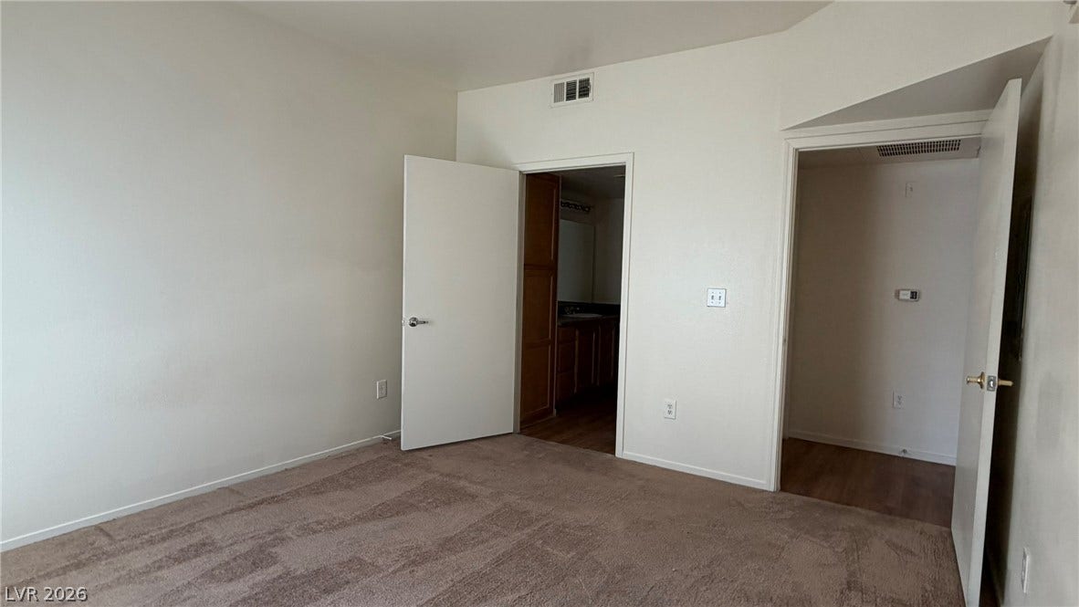 45 Maleena Mesa Street, #1912, Henderson, NV 89074 Plush carpeting and dual doorways define this versatile secondary bedroom space.