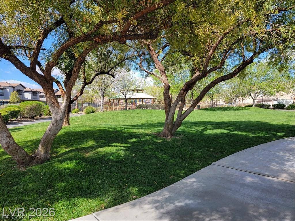 45 Maleena Mesa Street, #1912, Henderson, NV 89074 Mature trees shade a wide green lawn leading toward a neighborhood park gazebo.