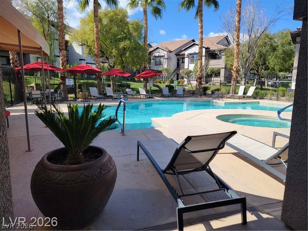 45 Maleena Mesa Street, #1912, Henderson, NV 89074 A sparkling community pool and spa are surrounded by towering palm trees.