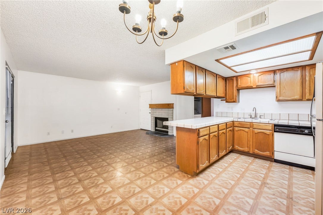 4340 Sanderling Circle, #78, Las Vegas, NV 89103 An open floorplan seamlessly connects the classic kitchen and spacious living area with patterned flooring.