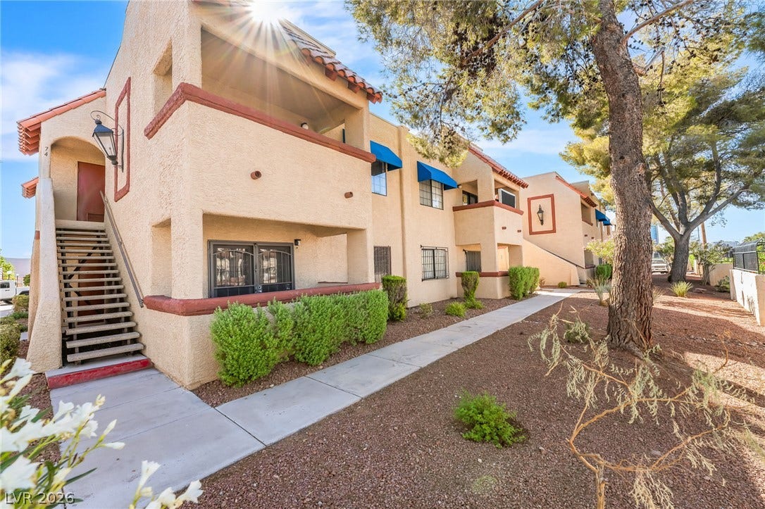4340 Sanderling Circle, #78, Las Vegas, NV 89103 Stucco exteriors and mature trees line the sunny concrete pathway of this residential community.