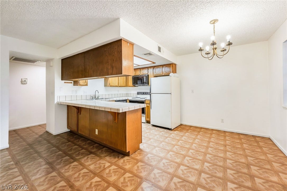4340 Sanderling Circle, #78, Las Vegas, NV 89103 An open kitchen and dining layout is defined by geometric pattern flooring.