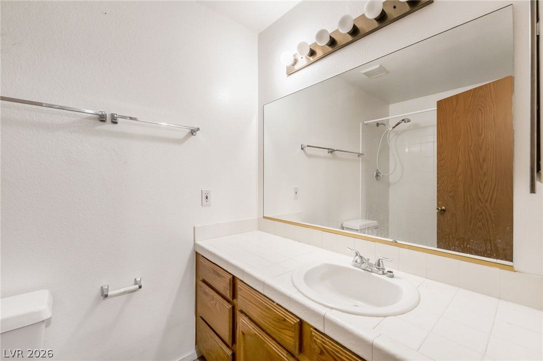 4340 Sanderling Circle, #78, Las Vegas, NV 89103 A spacious vanity counter and large mirror highlight this functional bathroom space.