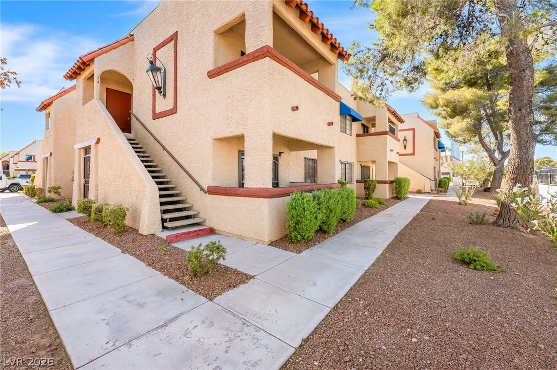4340 Sanderling Circle, #78, Las Vegas, NV 89103 Stucco exteriors and Spanish tile roofs define this multi-level residential building flanked by concrete pathways.
