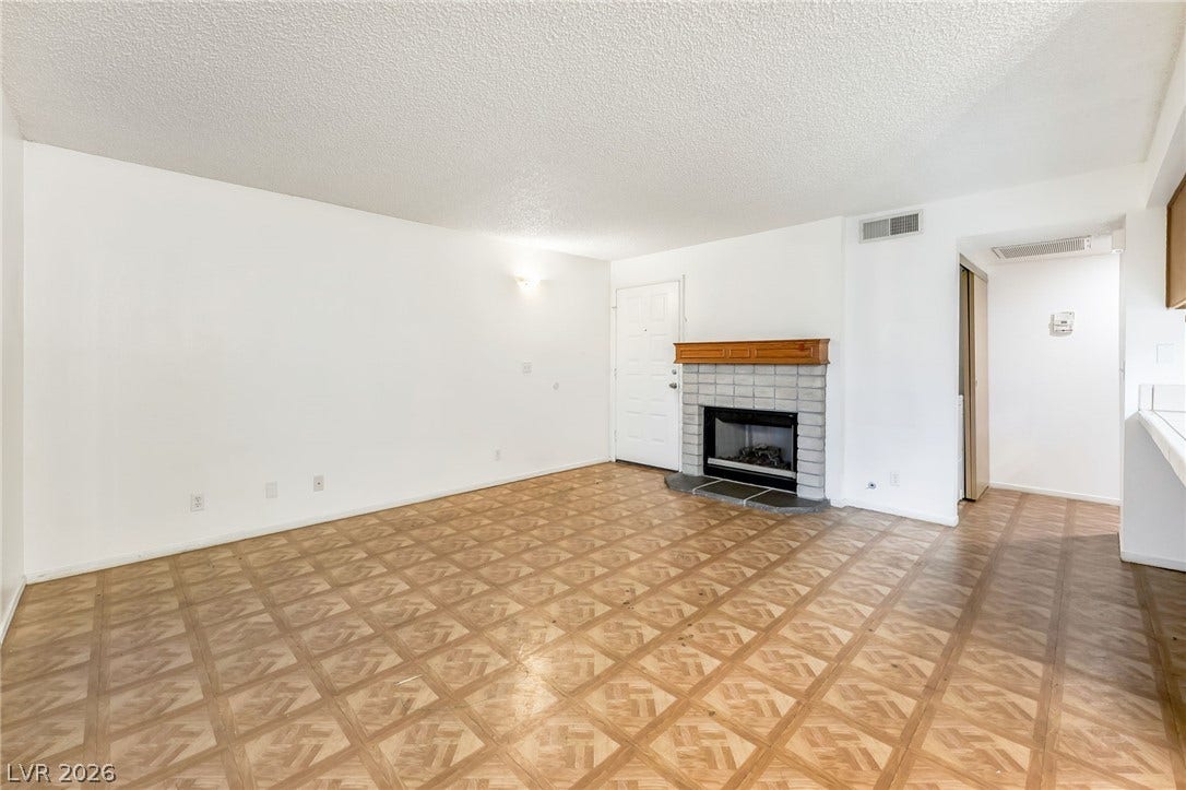 4340 Sanderling Circle, #78, Las Vegas, NV 89103 A classic fireplace and patterned flooring ground this open, versatile living space.