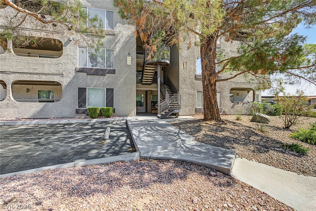701 Capri Drive, #10B, Boulder City, NV 89005 Mature trees shade the stucco exterior of this multi-level residential building.