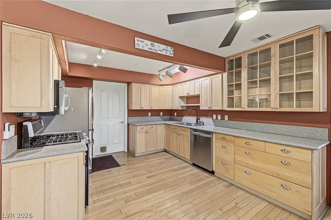 701 Capri Drive, #10B, Boulder City, NV 89005 Ample counter space and classic cabinetry define this functional kitchen space with wood flooring.