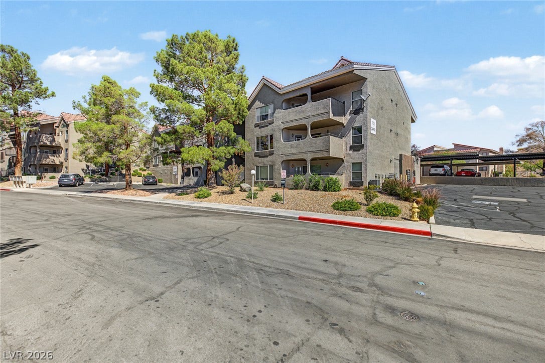 701 Capri Drive, #10B, Boulder City, NV 89005 Mature shade trees flank this multi-level residential building featuring covered private balconies.
