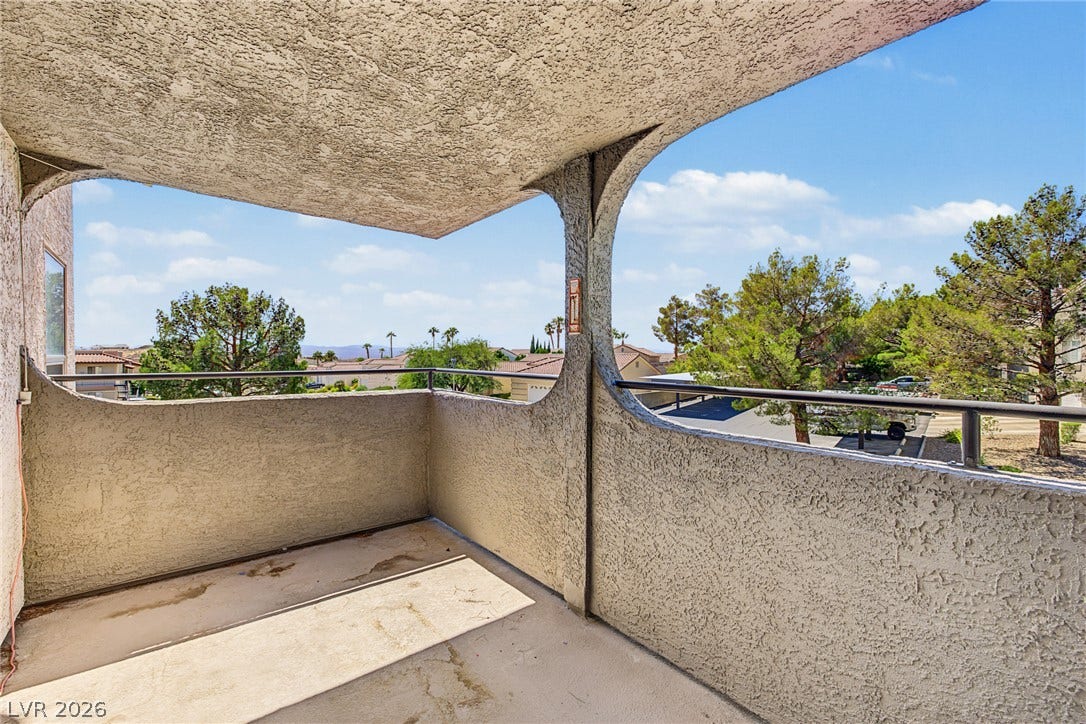 701 Capri Drive, #10B, Boulder City, NV 89005 A private covered balcony frames scenic neighborhood views through distinct architectural arches.