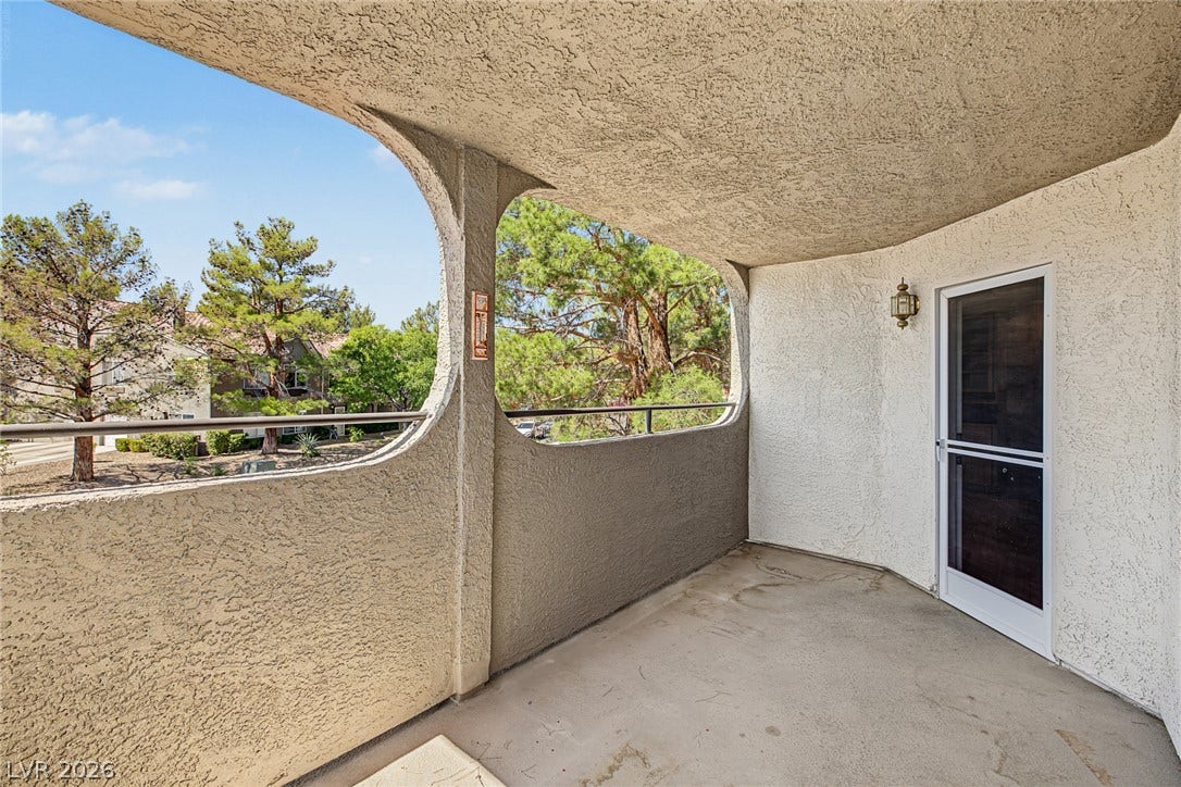 701 Capri Drive, #10B, Boulder City, NV 89005 Arched architectural openings frame leafy neighborhood views from this private covered concrete balcony.