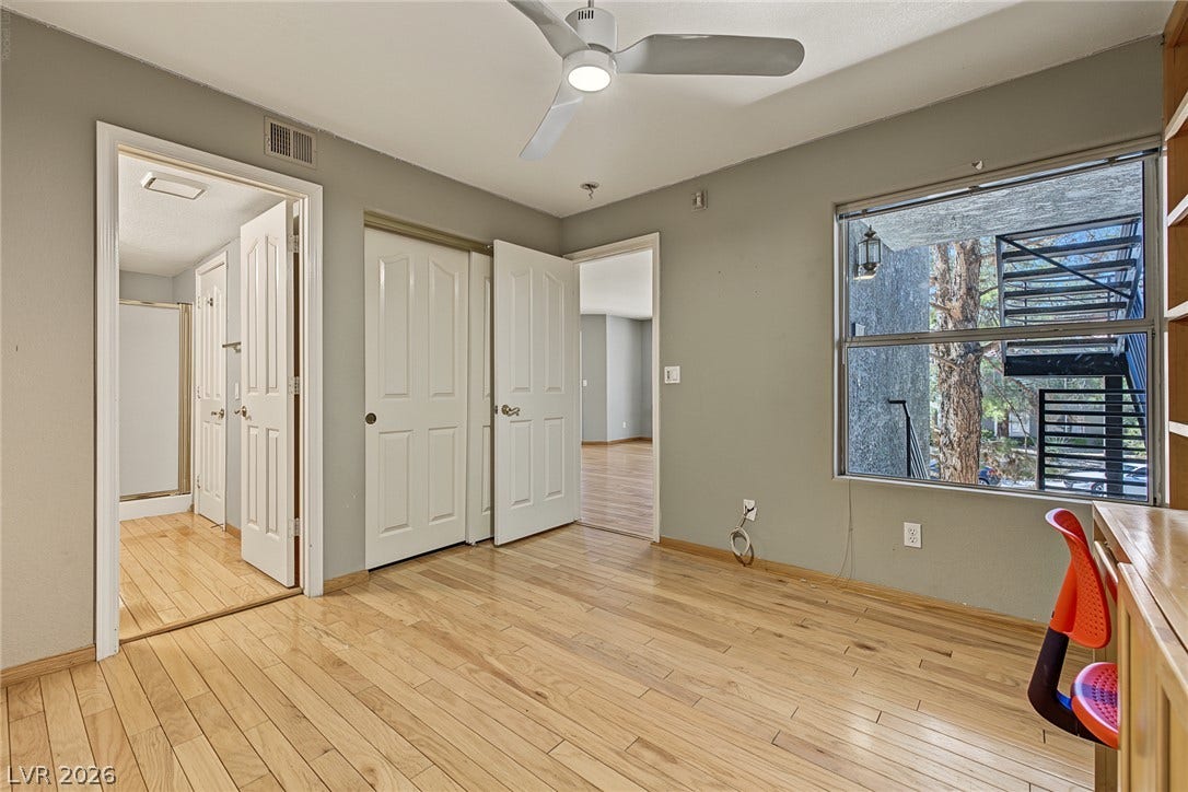 701 Capri Drive, #10B, Boulder City, NV 89005 Gleaming hardwood floors and a large picture window highlight this versatile secondary bedroom space.