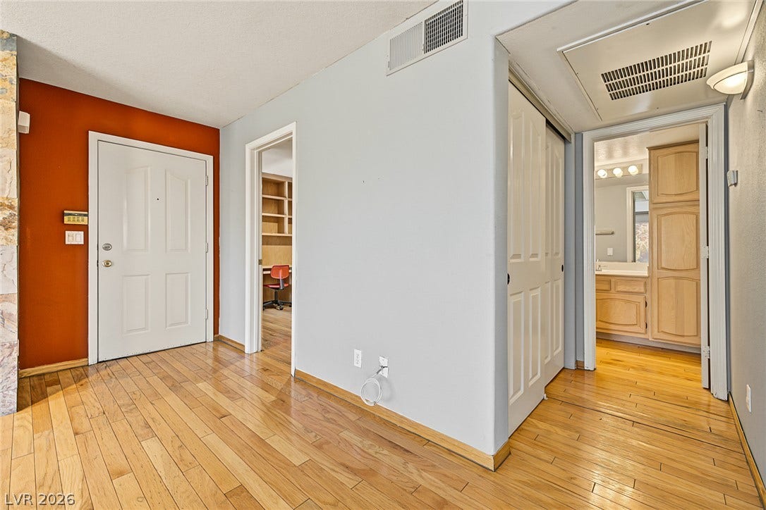 701 Capri Drive, #10B, Boulder City, NV 89005 Gleaming hardwood floors run throughout the entryway, leading to a functional hallway layout.