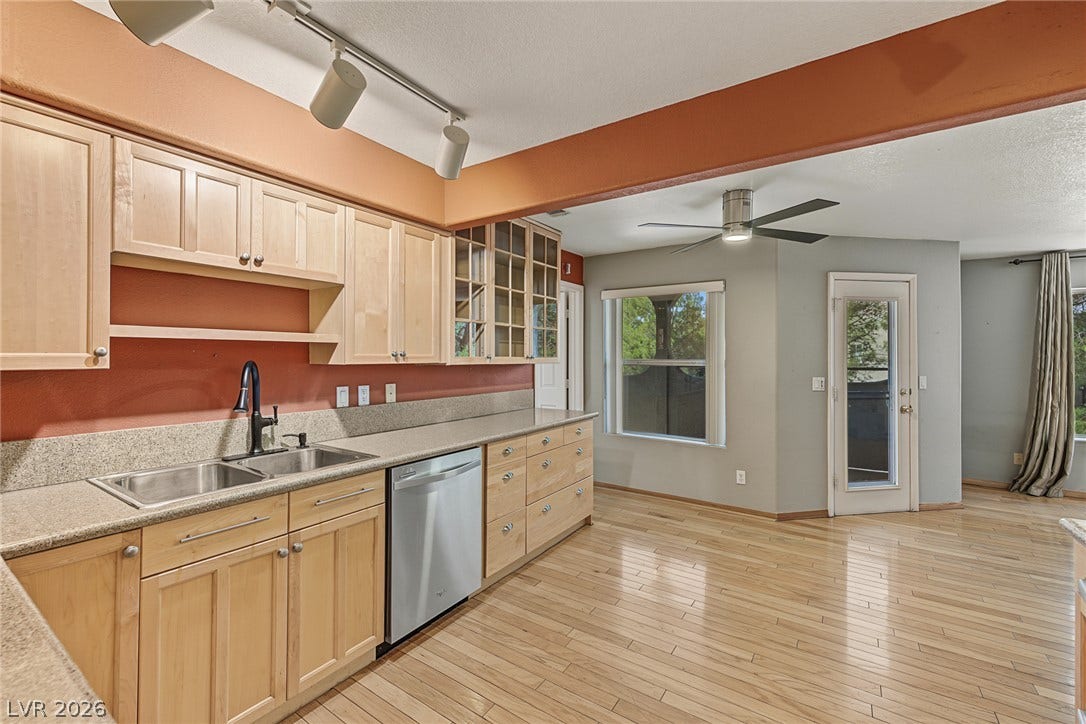 701 Capri Drive, #10B, Boulder City, NV 89005 Gleaming hardwood floors run through a spacious open kitchen with natural wood cabinetry.