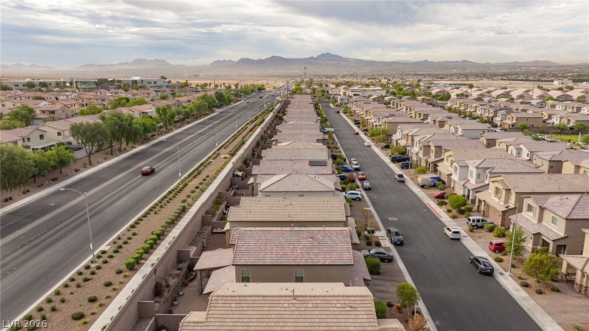 2728 Lindsey Springs Street, Las Vegas, NV 89142 Distant mountain silhouettes frame this neighborhood context captured from a high vantage point.