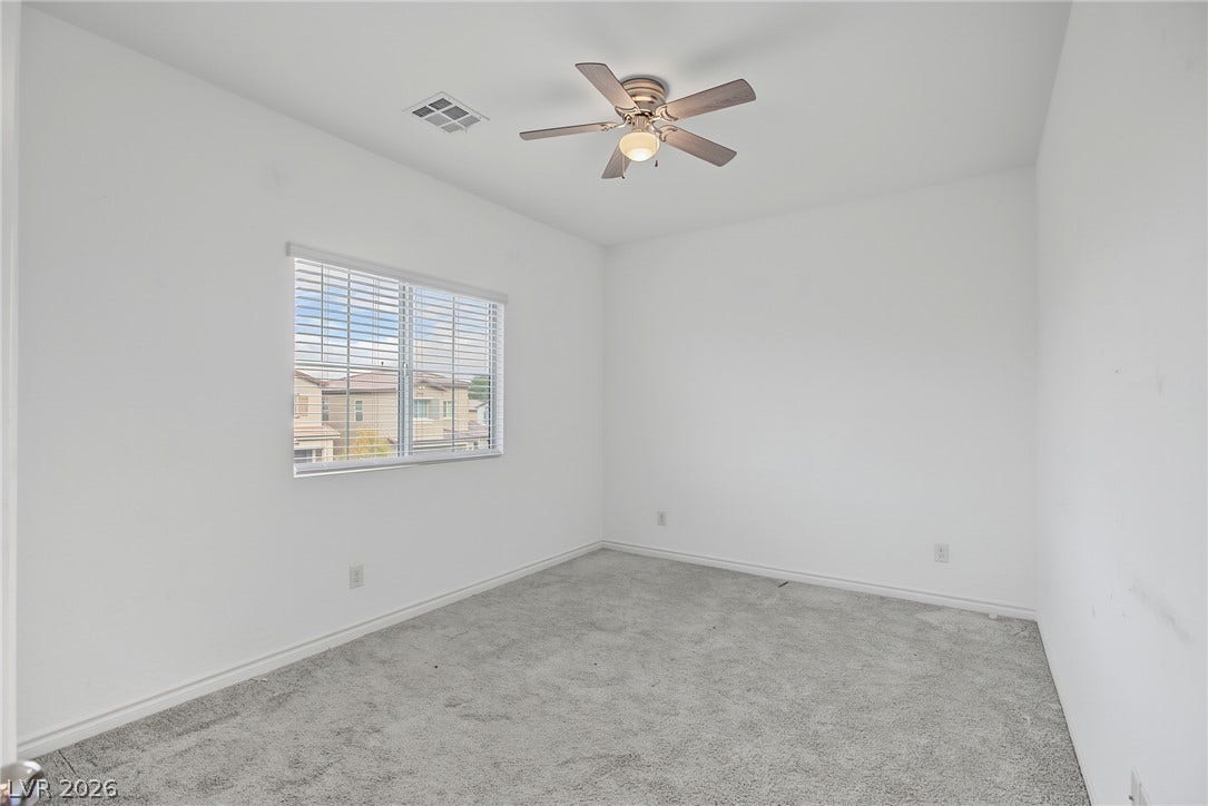 2728 Lindsey Springs Street, Las Vegas, NV 89142 Plush carpeted flooring and a wide window with integrated blinds highlight this versatile bedroom.