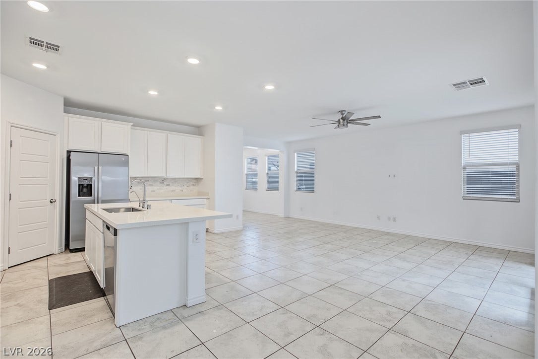 2728 Lindsey Springs Street, Las Vegas, NV 89142 An open kitchen merges seamlessly with a bright living area set on tile flooring.
