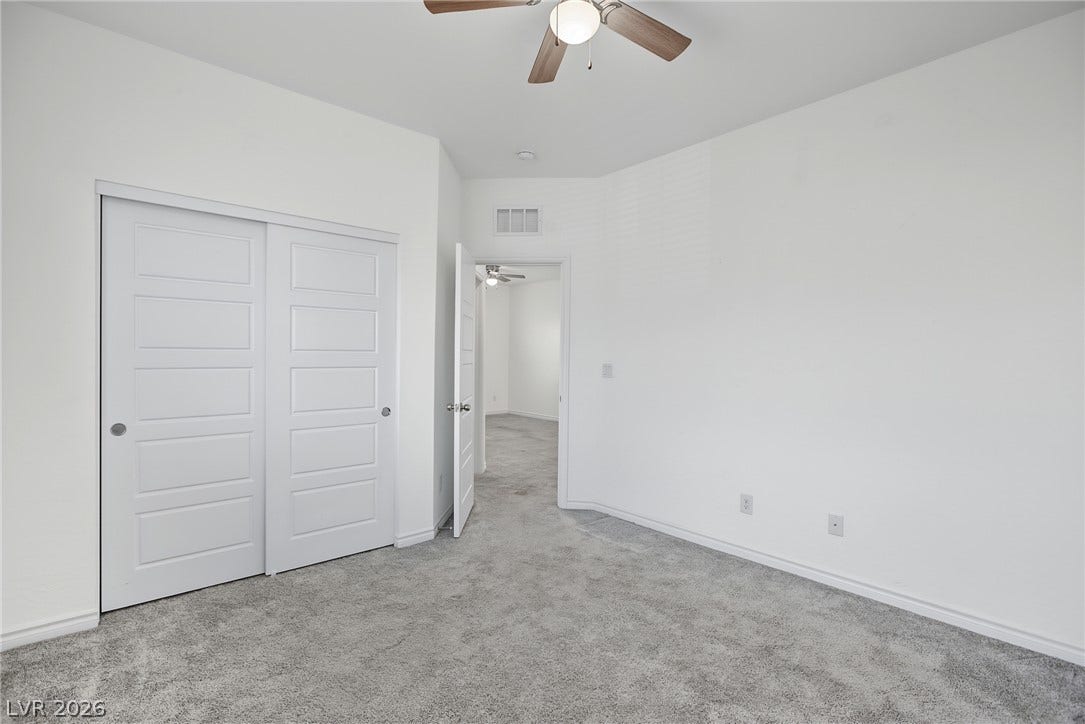 2728 Lindsey Springs Street, Las Vegas, NV 89142 Plush carpeting anchors this clean-lined bedroom featuring a sliding closet door.