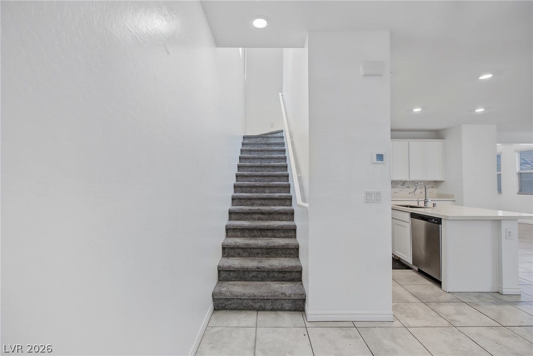 2728 Lindsey Springs Street, Las Vegas, NV 89142 Carpeted stairs ascend from the tiled main level adjacent to the kitchen.