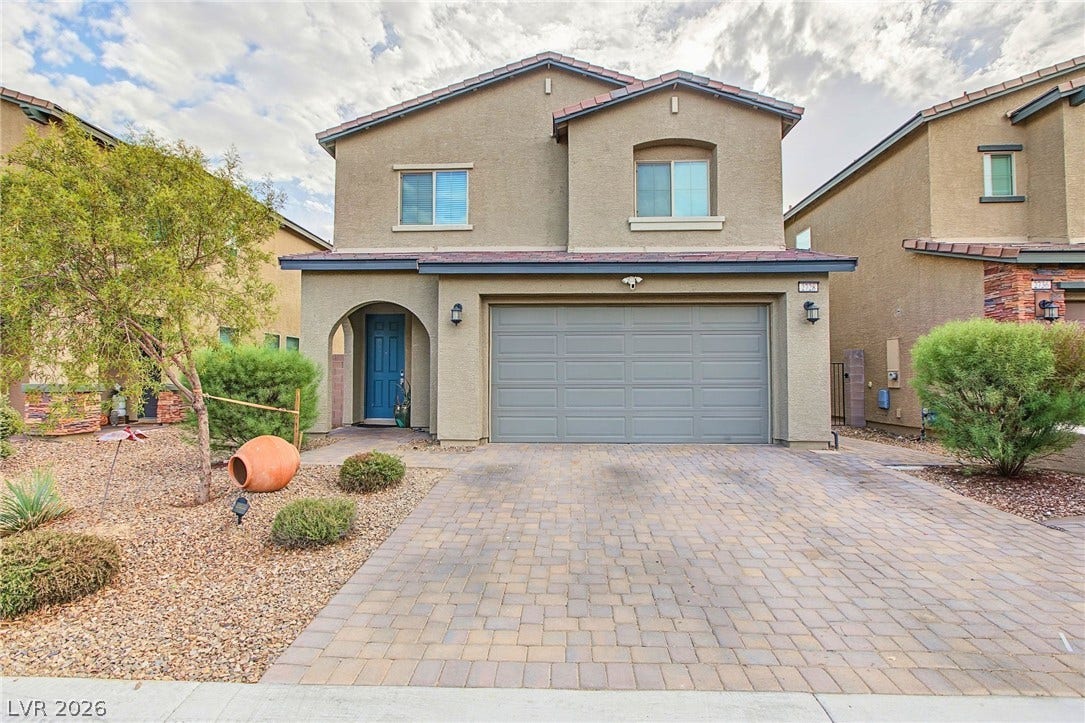 2728 Lindsey Springs Street, Las Vegas, NV 89142 A spacious paved driveway leads to a modern two-story exterior with a two-car garage.