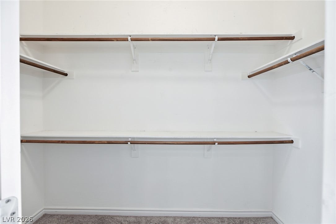 2728 Lindsey Springs Street, Las Vegas, NV 89142 Ample closet space features built-in shelving, hanging rods, and soft carpeting underfoot.
