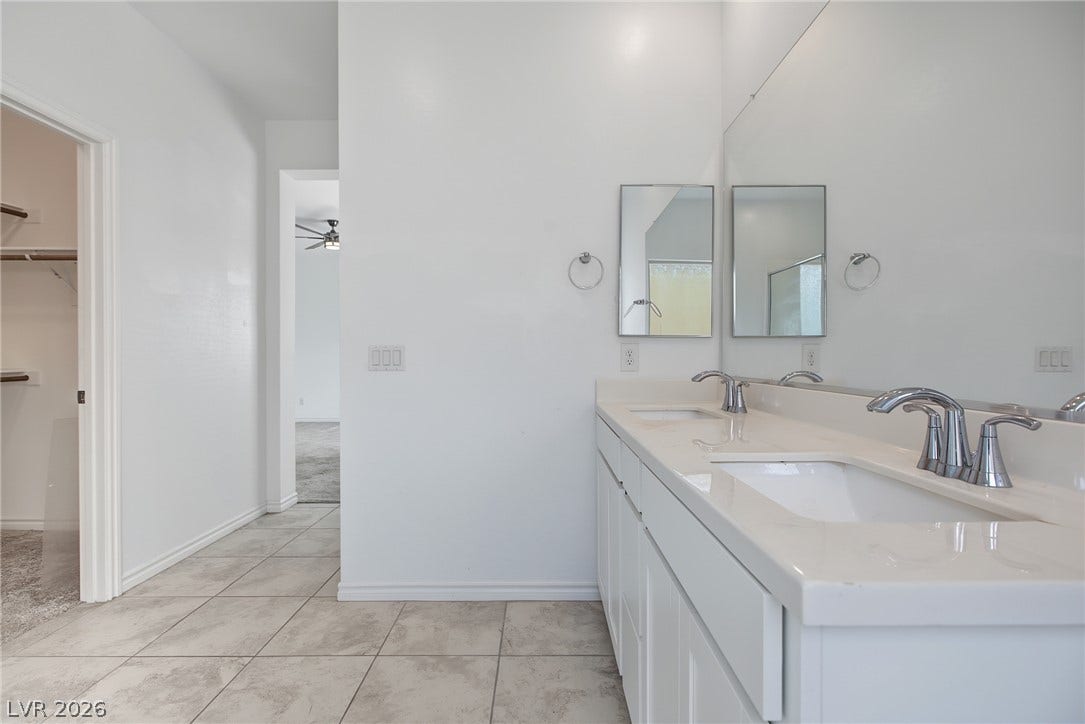 2728 Lindsey Springs Street, Las Vegas, NV 89142 Clean tile flooring and a double vanity define this spacious bathroom layout.
