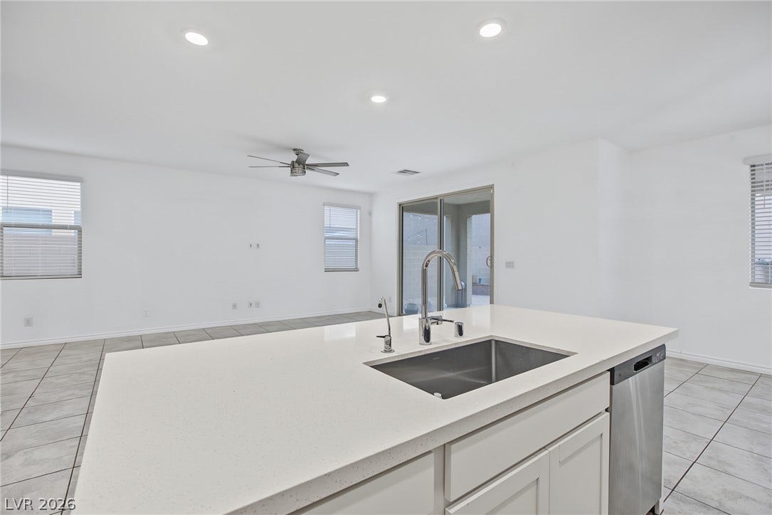 2728 Lindsey Springs Street, Las Vegas, NV 89142 Gleaming stone countertops and tile flooring define this bright, open kitchen and living area.