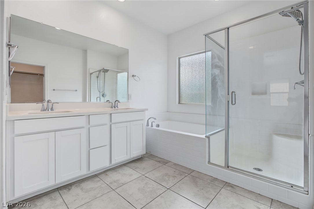 2728 Lindsey Springs Street, Las Vegas, NV 89142 Tiled flooring and a separate glass-enclosed shower elevate this bright master bathroom.