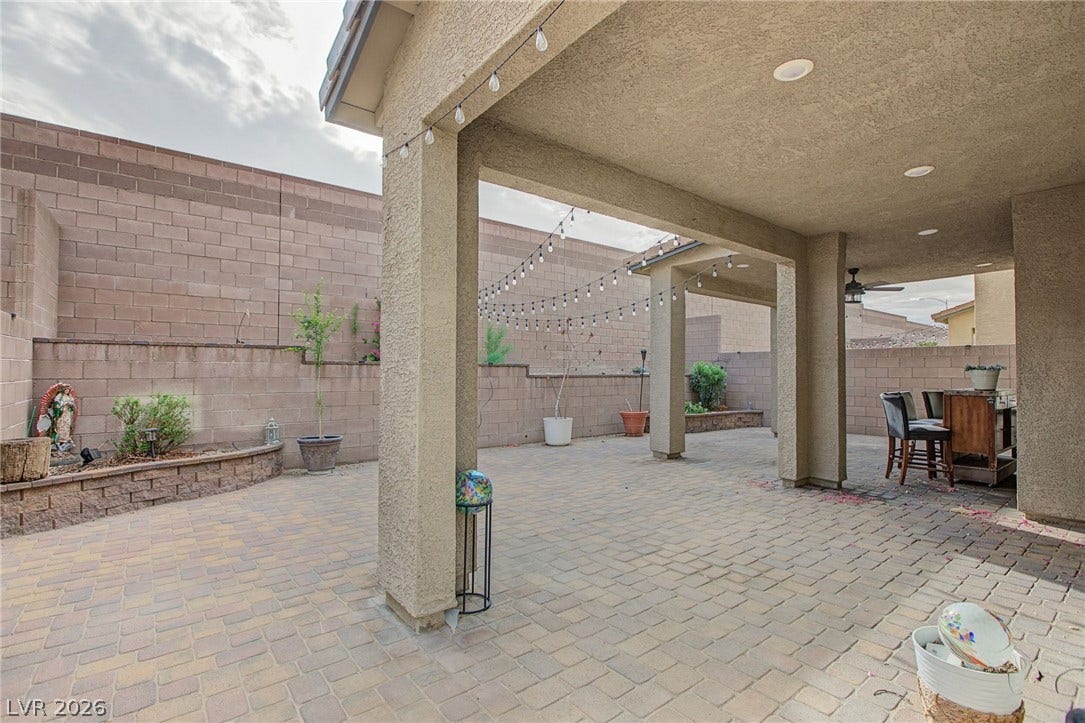 2728 Lindsey Springs Street, Las Vegas, NV 89142 An inviting covered patio features extensive pavers and structured pillars opening to the yard.
