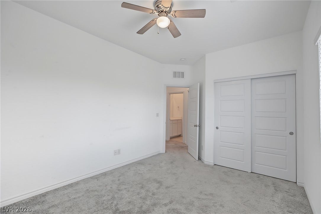 2728 Lindsey Springs Street, Las Vegas, NV 89142 A spacious bedroom offers plush neutral carpeting and a large sliding door closet.
