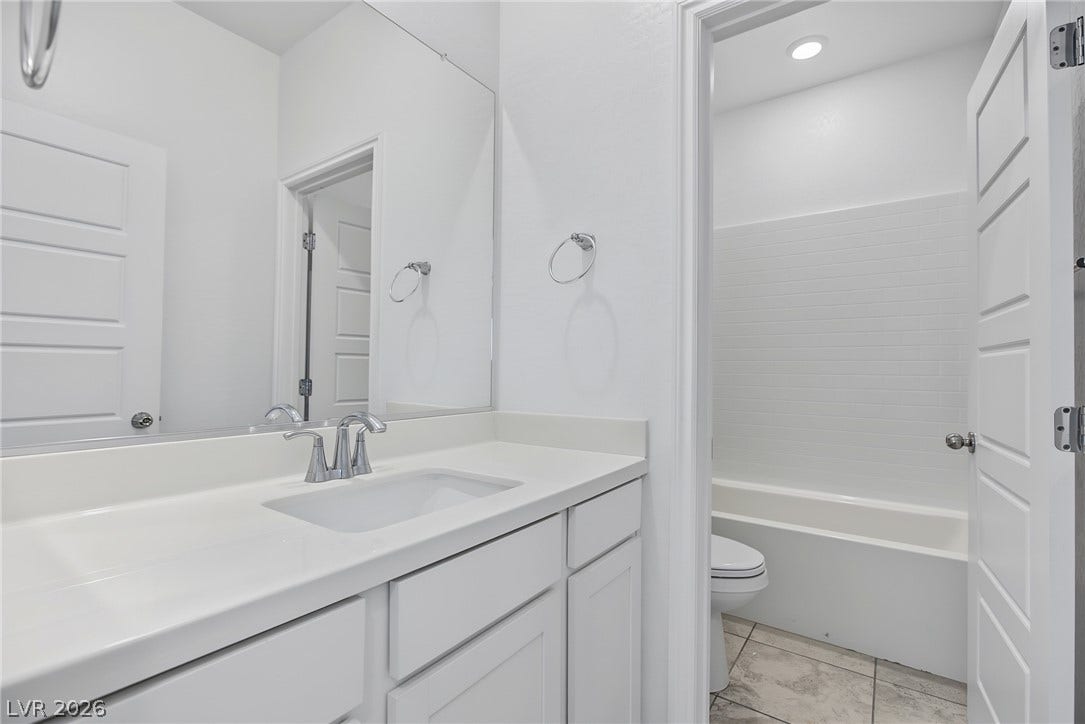 2728 Lindsey Springs Street, Las Vegas, NV 89142 Modern vanity and tiled tub surround highlight this clean bathroom layout.