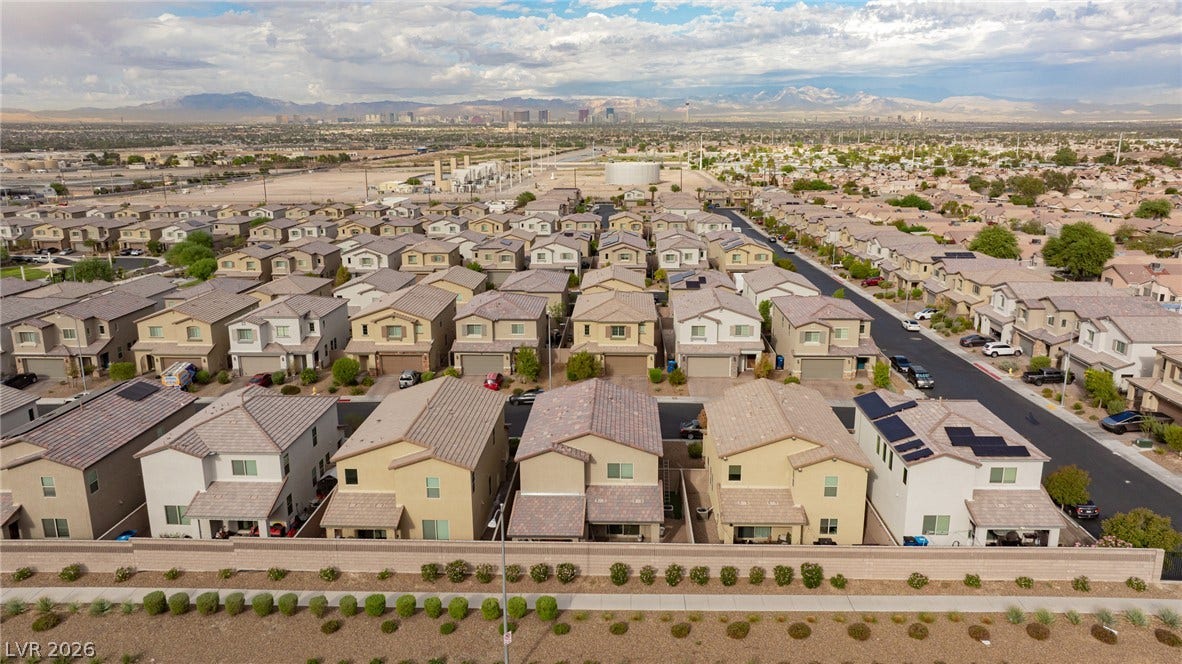 2728 Lindsey Springs Street, Las Vegas, NV 89142 Distant mountains frame a sprawling suburban neighborhood of modern multi-level homes.