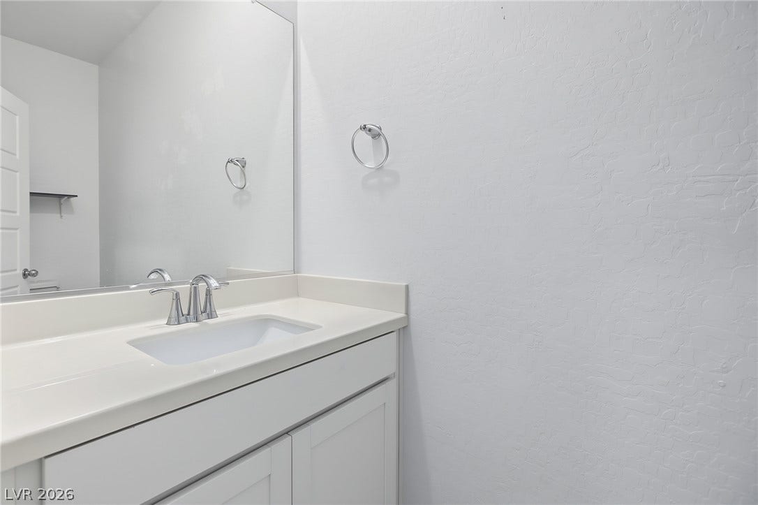 2728 Lindsey Springs Street, Las Vegas, NV 89142 Clean lines and a spacious vanity define this modern powder room.