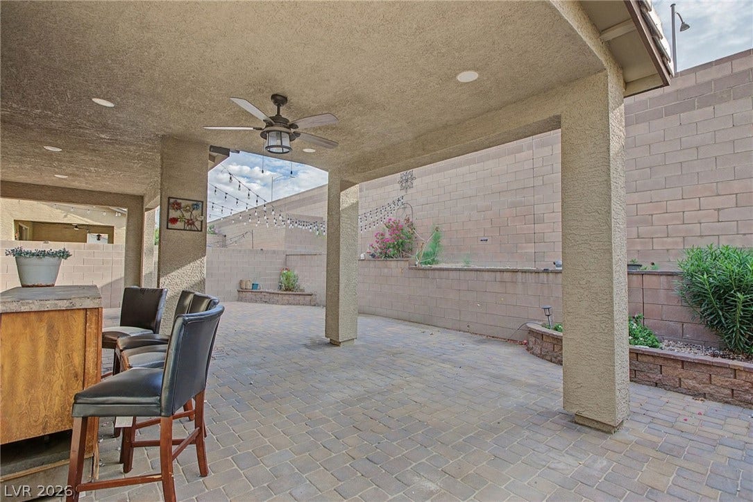 2728 Lindsey Springs Street, Las Vegas, NV 89142 An inviting covered patio offers durable paver flooring alongside structured pillars and built-in masonry planters.