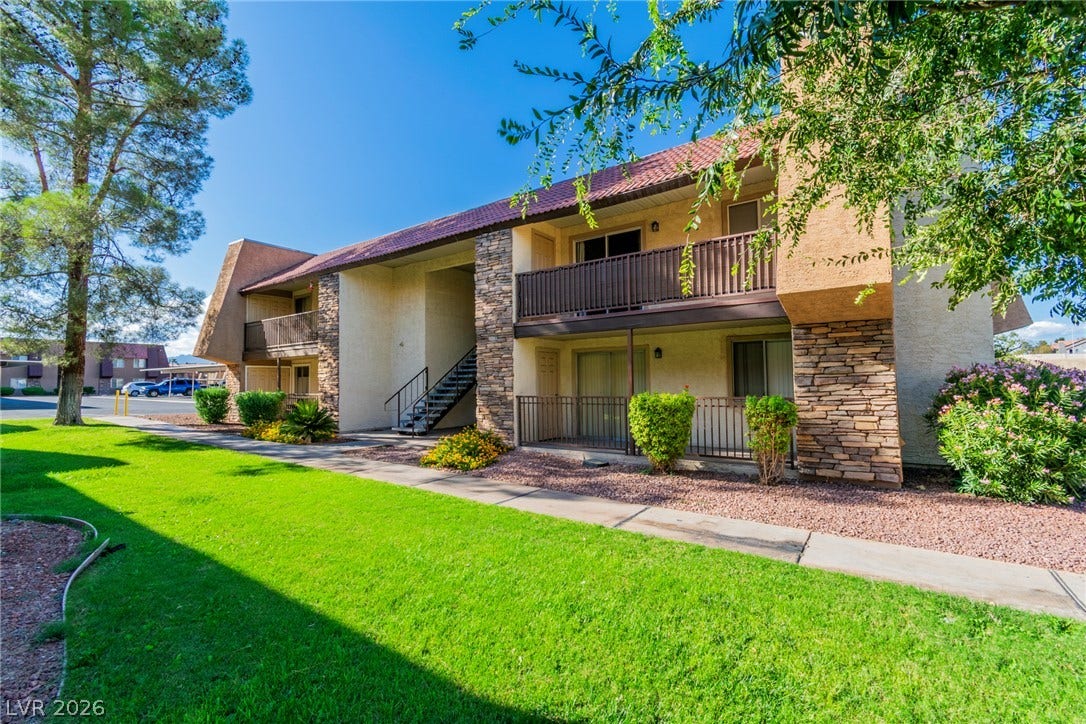 Manicured lawns and stone accents define this inviting multi-level residential exterior.